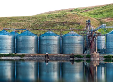 Panoramic shot of industrial buildings on the shore of the lake reflected in the water A panoramic shot of industrial buildings on the shore of the lake reflected in the water